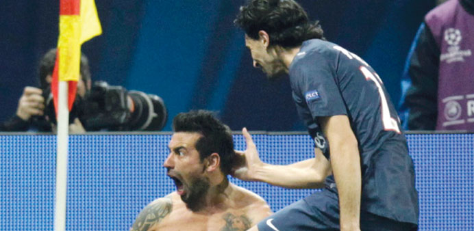 Paris St Germainu2019s Lavezzi celebrates with teammate Pastore after scoring a goal during their Champions League match against Valencia in Paris on Wedn