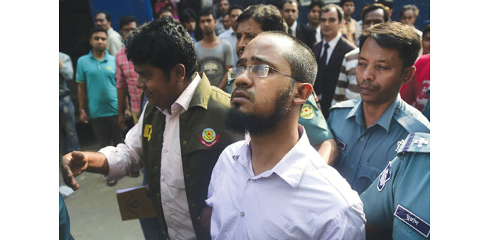 Police escort Farabi Shafiur Rahman, centre, as he appears in court following his arrest over the machete murder of an American blogger in Dhaka yeste