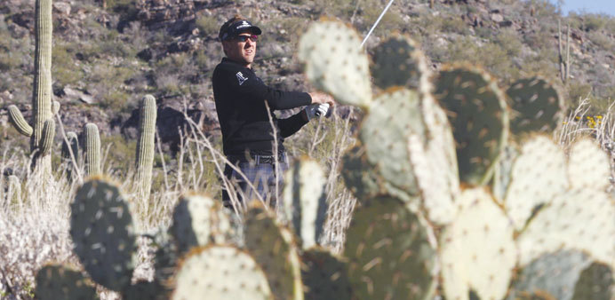 Ian Poulter of England watches his tee shot on the 16th hole during the quarter-final round of the  WGC-Accenture Match Play Championship golf tournam