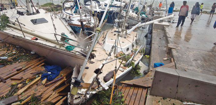 This handout photo taken by and received yesterday from Unicef Pacific shows storm damage to boats in Port Vila.