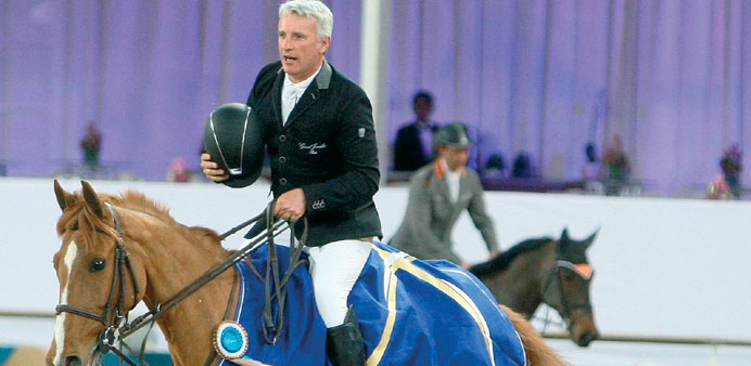 Frenchman Roger Yves Bost celebrates after his victory in the Big Tour CSI5* at the CHI Al Shaqab show jumping event at the Al Shaqab arena last night