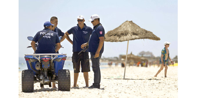  Policemen patrol the beach in front of the Riu Imperial Marhaba Hotel in Port El Kantaoui yesterday.