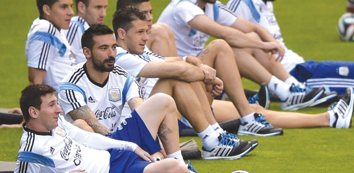 Argentina forward Lionel Messi (left) sits next to teammates during a training session at their base camp near Belo Horizonte on Thursday. (AFP)