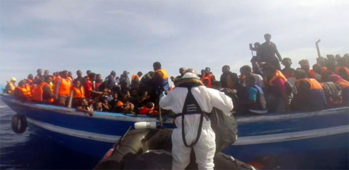 Italian coast guard taking part in a rescue operation of a boat carrying migrants