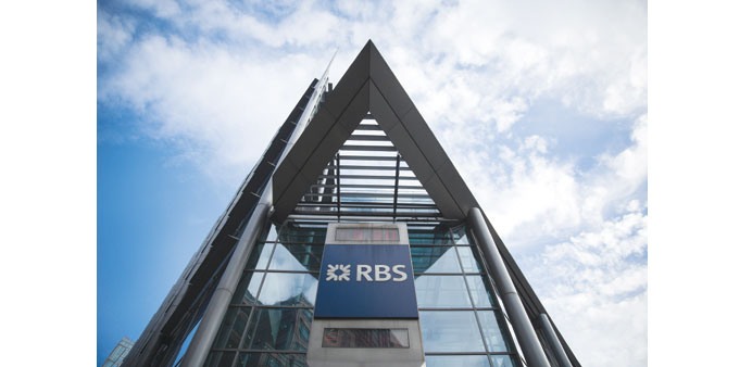 The RBS logo is seen outside its headquarters in London. Under an overhaul announced last week, RBS may eliminate as many as 14,000 jobs at the invest
