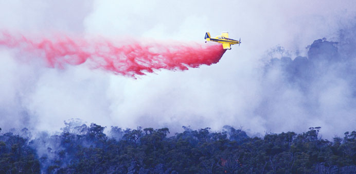 A prop plane dropping fire retardant material over the bushfires in the Grampians in the Australian state of Victoria.