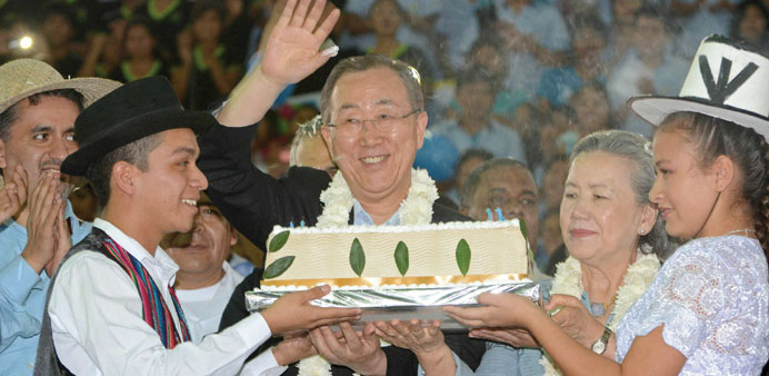 UN General Secretary Ban Ki-moon waves as he holds his 70th birthday cake at El Torno in Santa Cruz.