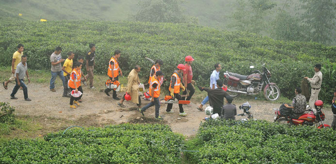 Rescue workers arrive to search the scene of a landslide at Tingling village near Mirik some 60km from Siliguri yesterday.