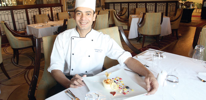 Chef Mohamed Baz shows off a beautifully set plate of Iced Passion Fruit Chiboust.