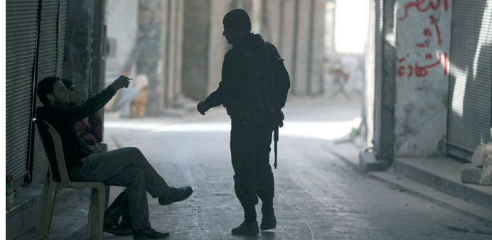 Fighters from the Free Syrian Army patrol a town in Aleppo.