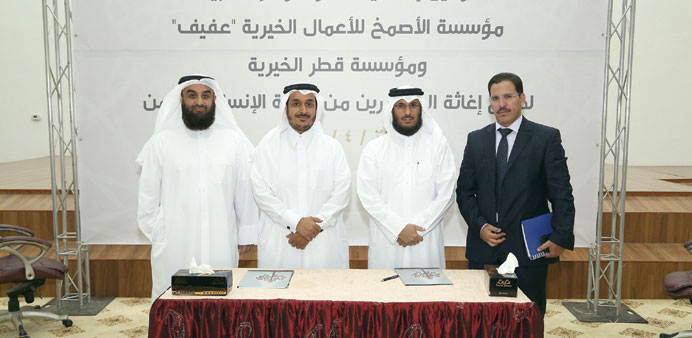 QC and Al Asmakh Foundation officials at the signing ceremony.