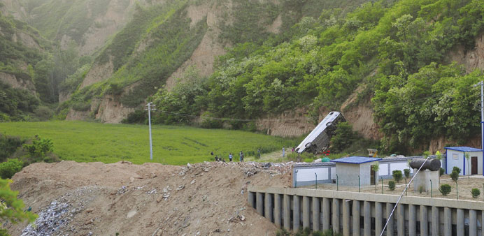 A bus is seen after overturning and falling into a valley in Chunhua county of Xianyang, Shaanxi province, China yesterday.