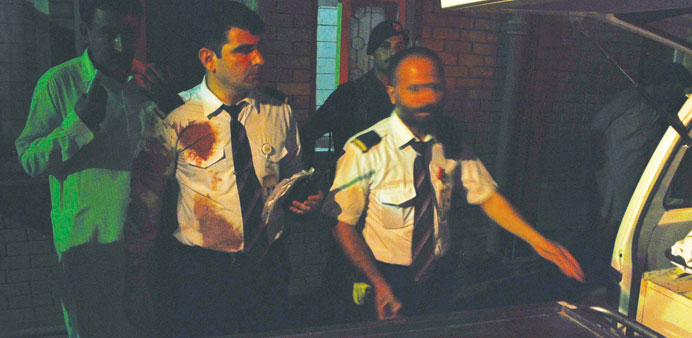 Injured crew members of a Pakistan International Airlines (PIA) plane arrive at a hospital in Peshawar early yesterday.