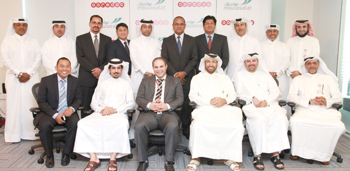 Mowasalat and Ooredoo officials at the partnership agreement signing ceremony yesterday.