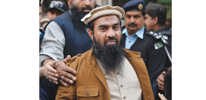 Security personnel escort Zaki-ur-Rehman Lakhvi, centre, as he leaves the court after a hearing in Islamabad on January 1. 
