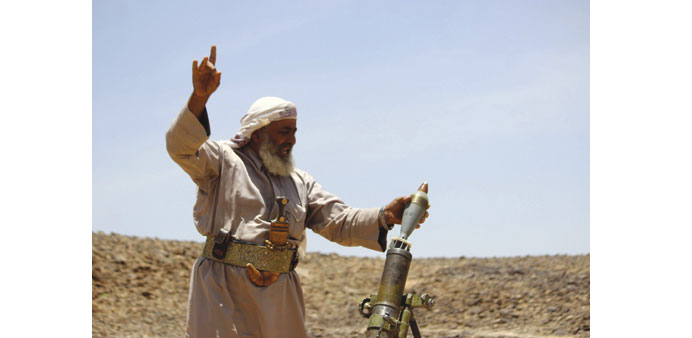 A fighter loyal to Yemenu2019s President Abd-Rabbu Mansour Hadi fires a mortar shell during clashes with Houthi rebels in the area of Jaadan, in Marib pro