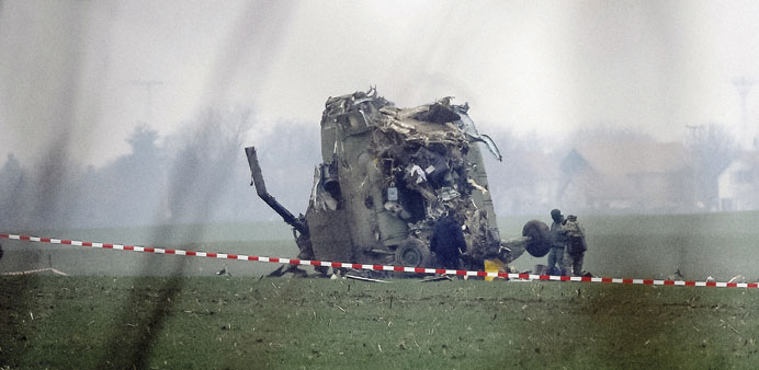 Army soldiers stand next to the wreckage of the Serbian Mi-17 type military helicopter that crashed near Belgrade airport.