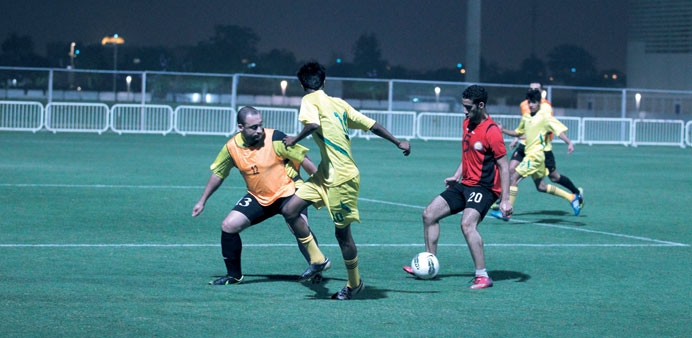 Players vie for the ball in the opening match of the u2018Welcome to Aspire Ramadanu2019 football tournament taking place at Outdoor Pitch 10.