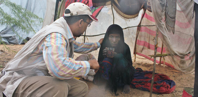 An official with a flood-affected person in Somalia.