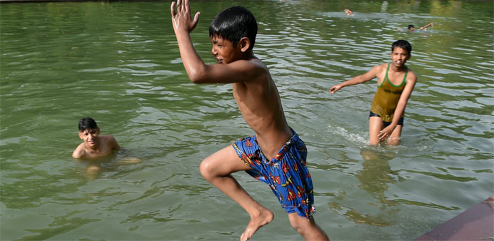 An Indian child dives in a water to cool himself off in New Delhi 