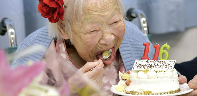 Misao Okawa eats her birthday cake on her 116th birthday in Osaka in this photo released by Kyodo.