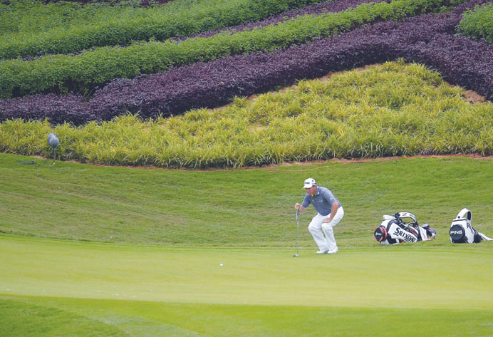 Lee Westwood of England lines up a putt on the fifteenth hole during the second round of the Maybank Malaysian Open golf tournament in Kuala Lumpur ye