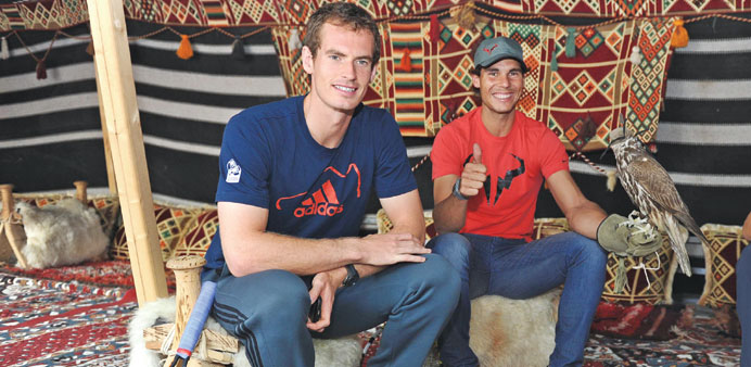 Andy Murray (left) and Rafael Nadal pose with a falcon during a visit to Souq Waqif yesterday.