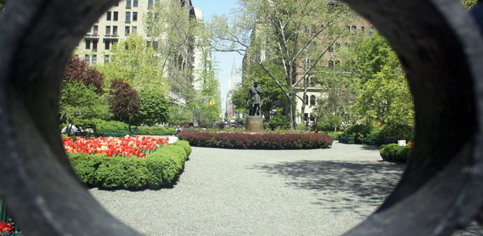 * Gramercy Park, a gated private park and oasis of calm in New York City, seen through its wrought-iron gates.