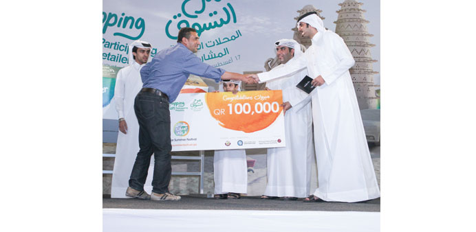 The QR100,000 cash prize winner of the Shopping Fun raffle draw.