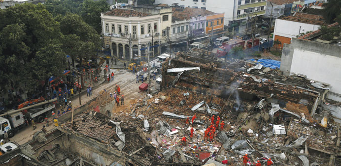 Rescue workers remove debris after the explosion in Rio de Janeiro.