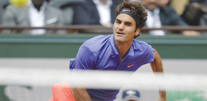 Switzerlandu2019s Roger Federer serves to Bosnia-Herzegovinau2019s Damir Dzumhur during his third round match in Paris yesterday. (AFP)