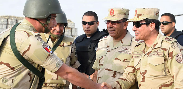 Egyptian President Abdel Fattah al-Sisi (R) greets members of the Egyptian armed forces