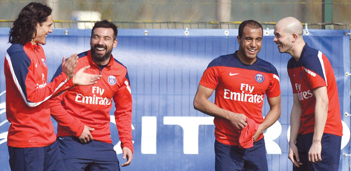 Paris Saint-Germain forwards Edinson Cavani (left),  Ezequiel Lavezzi, Lucas Moura and defender Christophe Jallet  share a laugh during  training sess