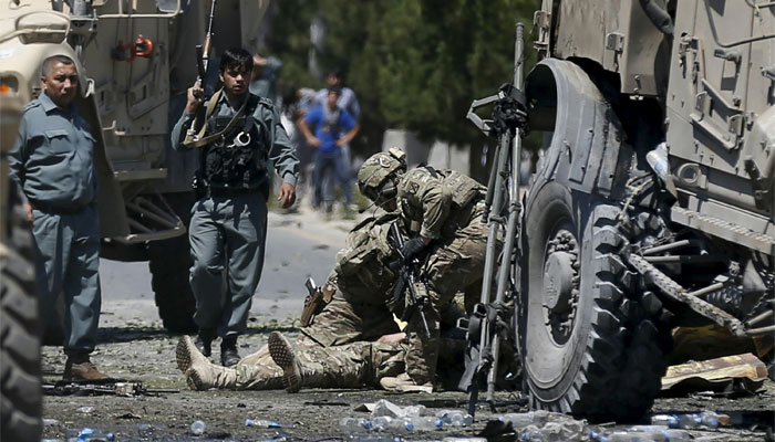 U.S. soldiers attend to a wounded soldier at the site of a blast in Kabul, Afghanistan. Reuters
