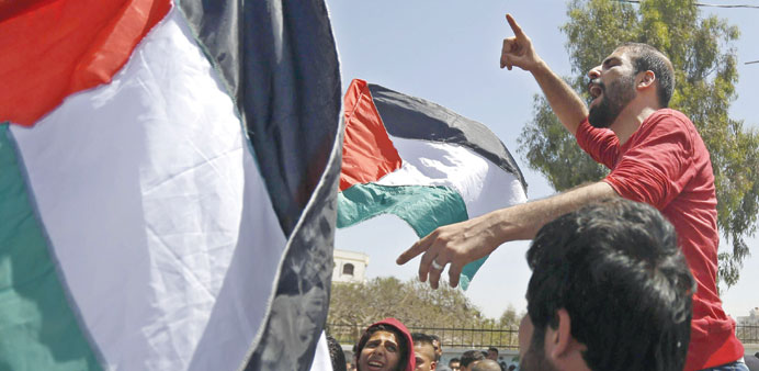 Demonstrators chant slogans during the rally in Gaza City yesterday.