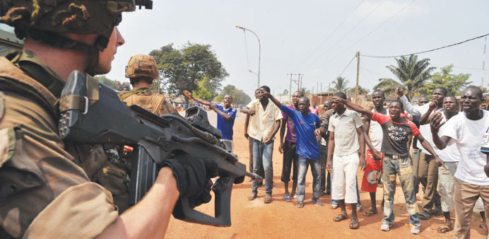 Civilian supporters of the anti-balaka Christian militia challenge French soldiers u2013 part of the Sangaris Operation u2013 patrolling in Bangui.