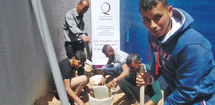 Palestinians getting training at the Qatar Charity project.