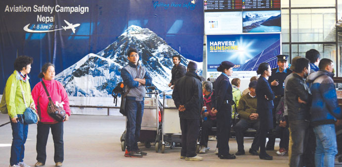 Stranded passengers wait for flights to resume at Tribhuvan International Airport in Kathmandu yesterday.