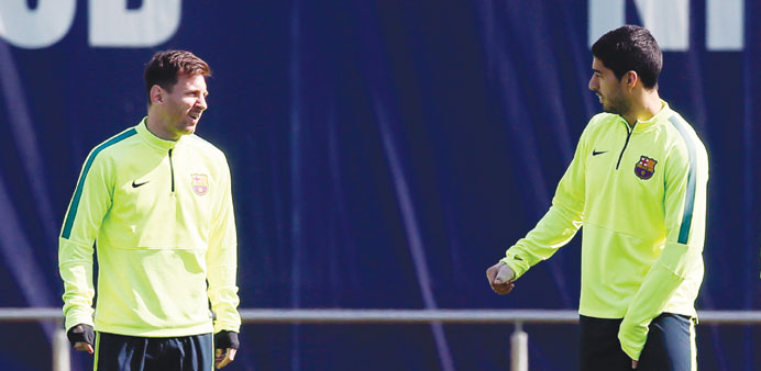Barcelonau2019s Lionel Messi (left) and Luis Suarez attend a training session at Joan Gamper training camp, near Barcelona.