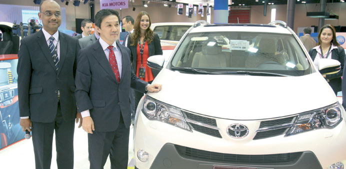 Toyota and AAB officials show off the new RAV4 MY at the AAB pavilion at the Doha Exhibition Center yesterday. PICTURE: Jayaram