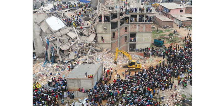 In this photograph taken on April 25, 2013, Bangladeshi volunteers and rescue workers are pictured at the collapsed Rana Plaza garment factory complex