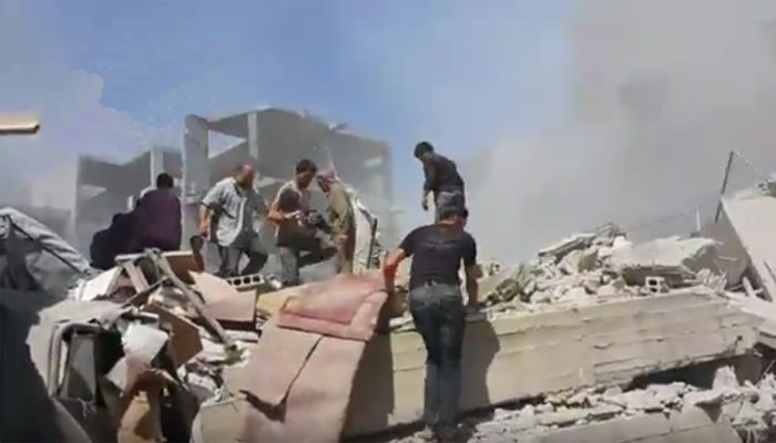 People search among the ruins of building after the air strikes