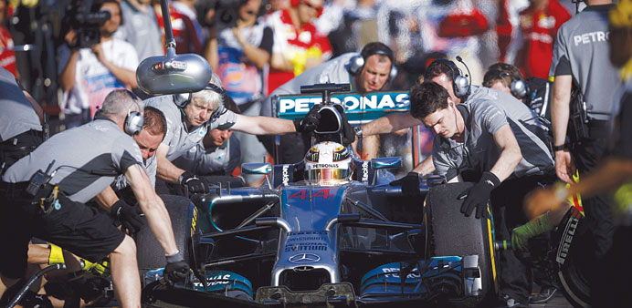 Mercedesu2019 British driver Lewis Hamilton is helped by team mechanics during the second practice session at the Albert Park circuit in Melbourne yesterd