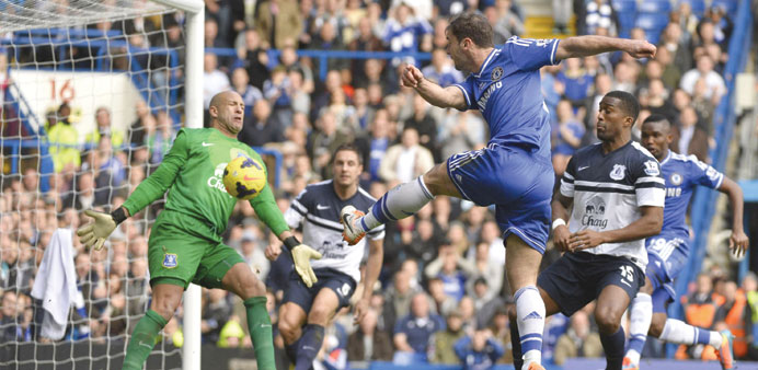 Everton goalkeeper Tim Howard (left) saves a shot from Chelseau2019s Branislav Ivanovic during their English Premier League clash at Stamford Bridge in Lo