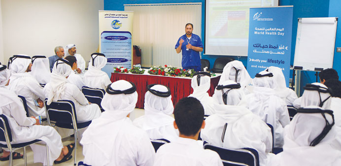 Students during a lecture on healthy lifestyle at a school.