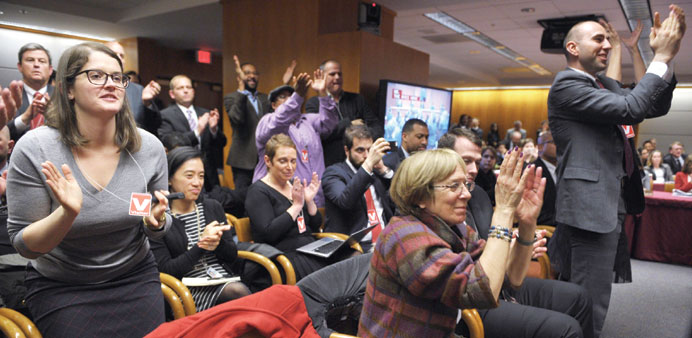  Attendees applaud after FCC chairman Wheeler announced the FCC ruling on Net neutrality in Washington, DC.