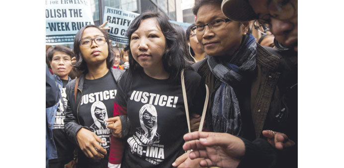 Erwiana Sulistyaningsih (centre), a former Indonesian domestic helper, arrives to the district court in Hong Kong yesterday. 