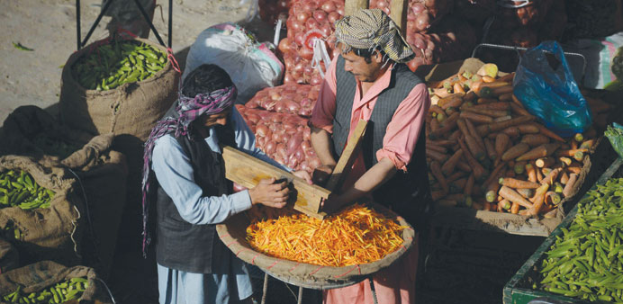 An Afghan farmer sells fruit and vegetables at a market in Mazar-i-Sharif.
