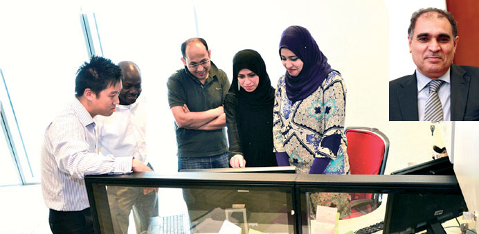Some of the scientists in a  research activity at the QCRI office. INSET: Dr Ahmed Elmagarmid: QCRIu2019s executive director  