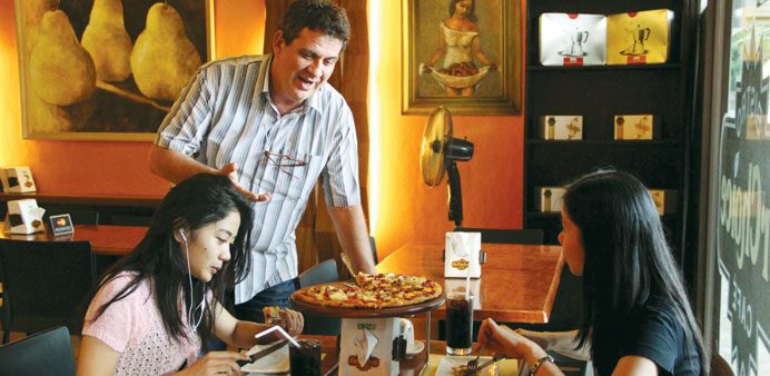 Rolando del Torchio serving customers at his restaurant in Dipolog city.